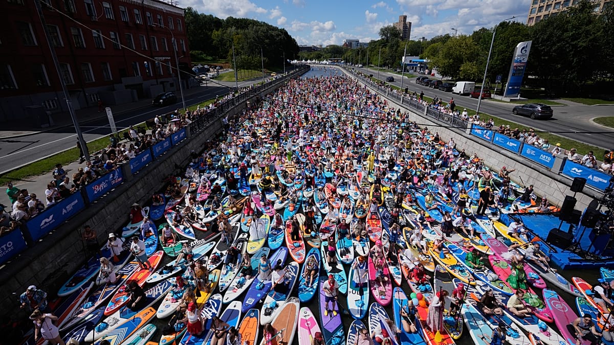 Costumed paddleboarders parade down Moscow River in carnival