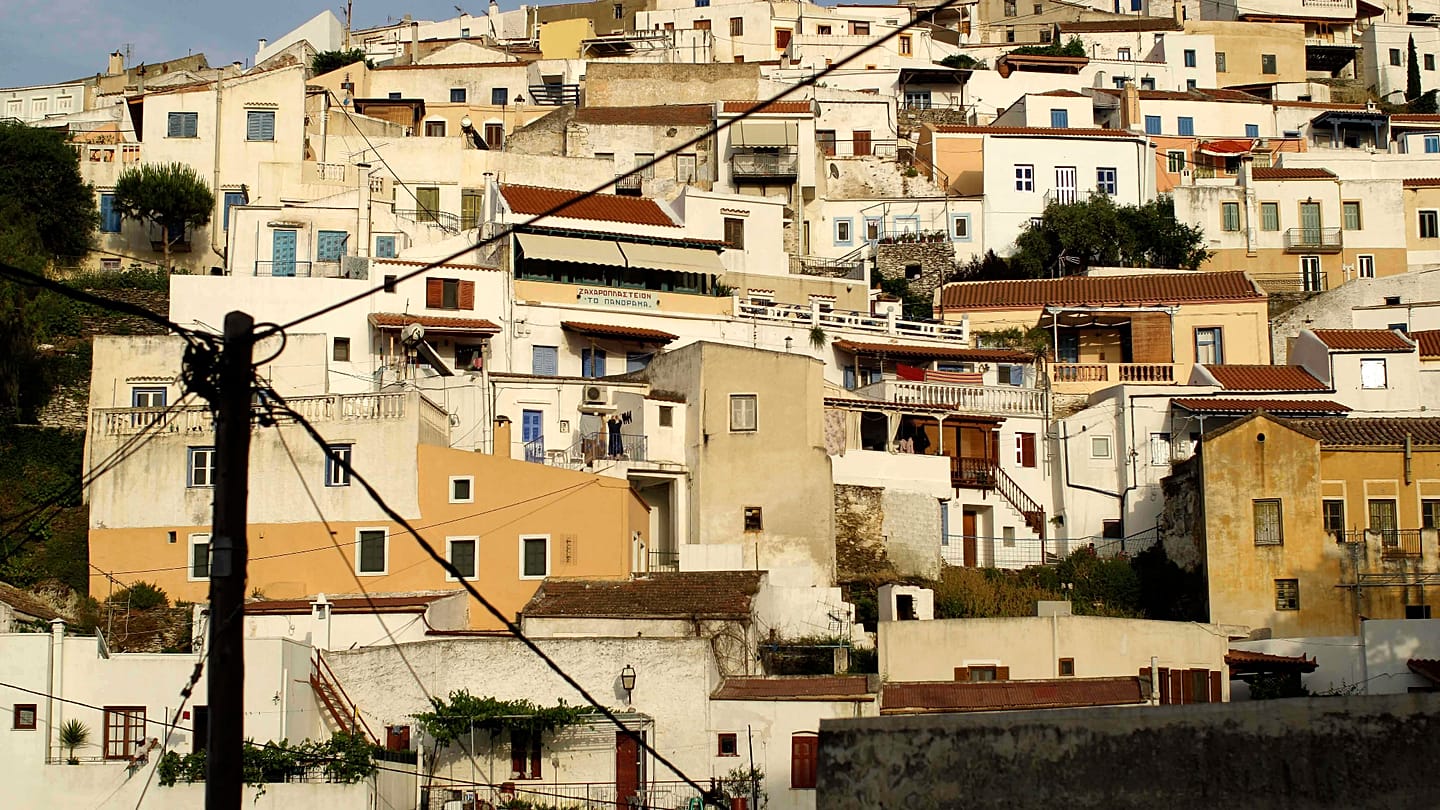 Kea's architectural identity: stone houses, vibrant hues, and watermills