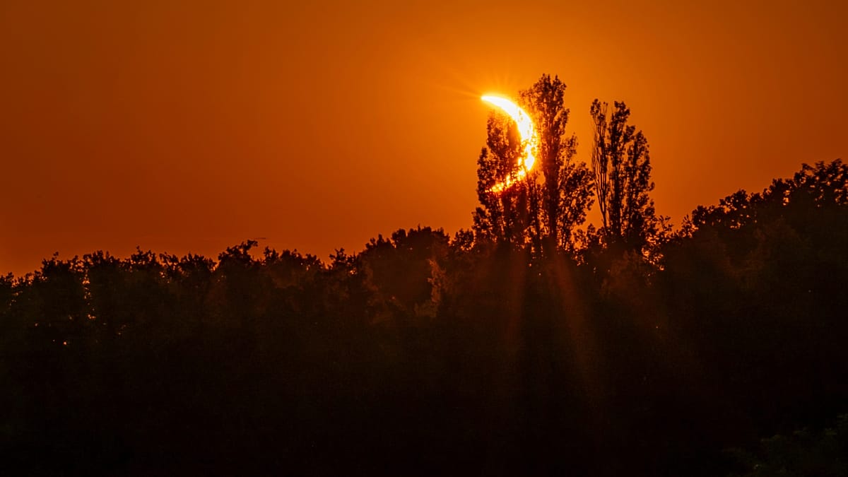Solar eclipse turns Pyrenees sky red as hikers watch from Pic du Midi