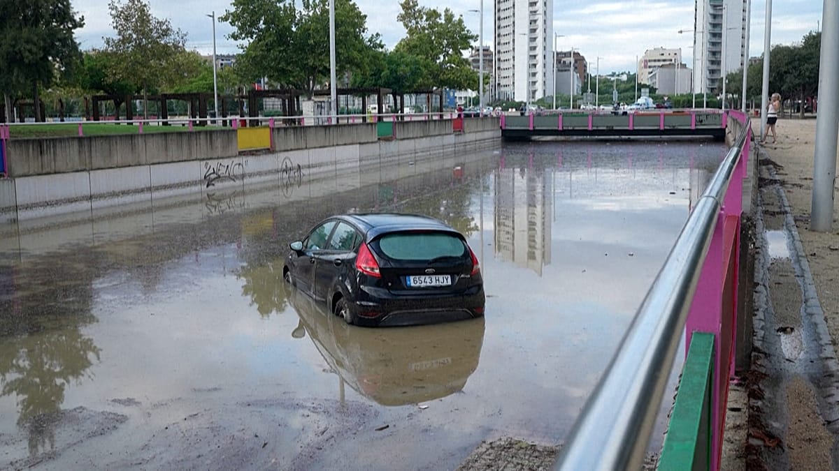 Valencia suburb Torrent digs out after 96mm downpour floods streets